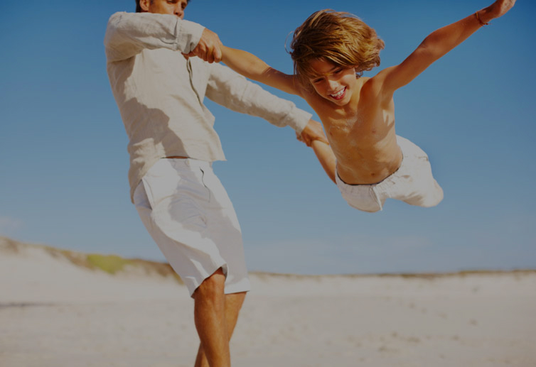 Dad and Son playing on Orange Beach Alabama's beaches