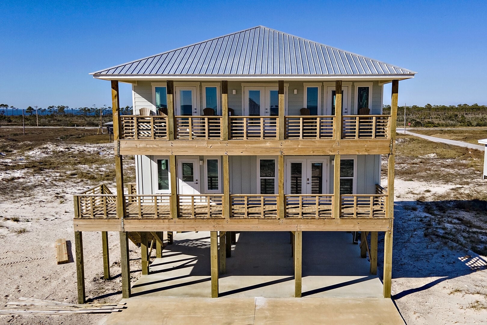 Raised beach house with wraparound decks at A Wava Sunshine in Fort Morgan, Alabama