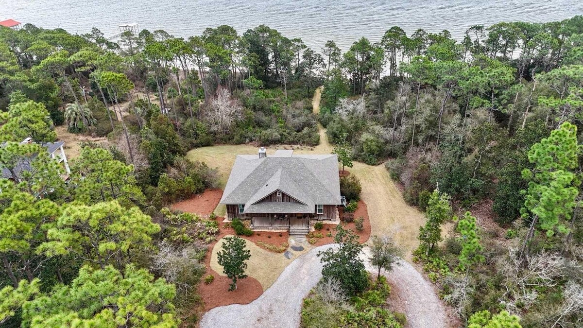 Aerial view of house in the woods on Perdido Bay at Beckoning on Perdido Bay in Lillian, Alabama