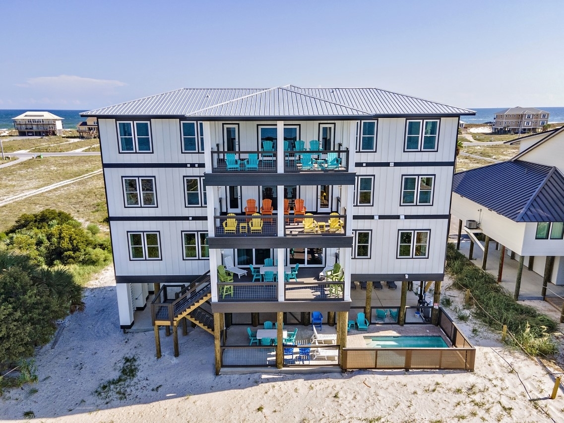 Beach house with pool and balconies at Black Tie Escape in Gulf Shores, Alabama