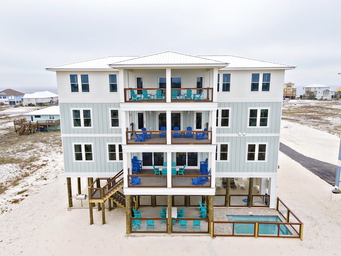 Beach house with pool and balconies at Blessed Together in Gulf Shores, Alabama