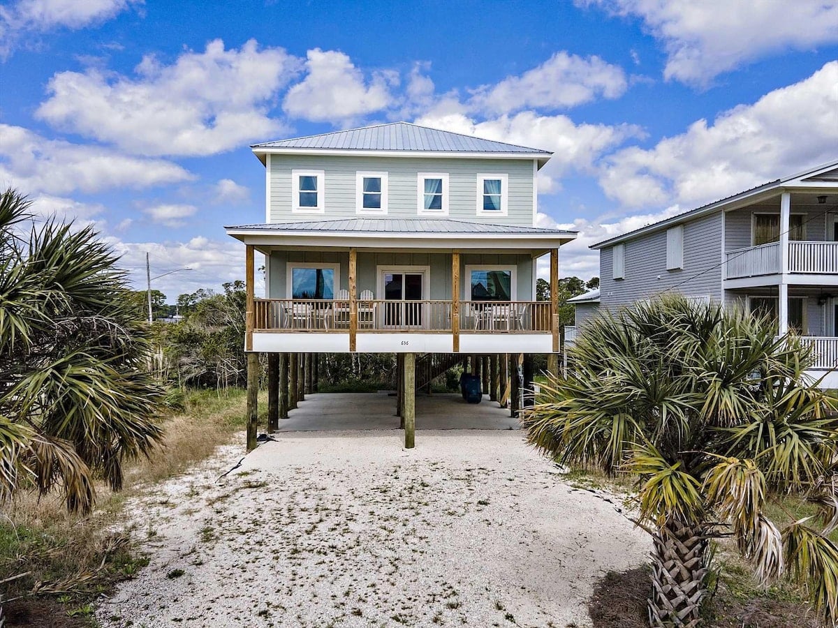 Beach house with palm trees at Close Enough in Gulf Shores, Alabama