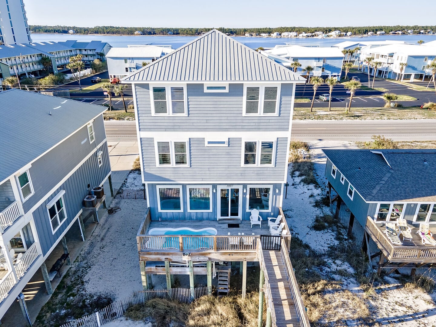 Gray beach house with back deck at Cookin Up Fun 2 in Gulf Shores, Alabama