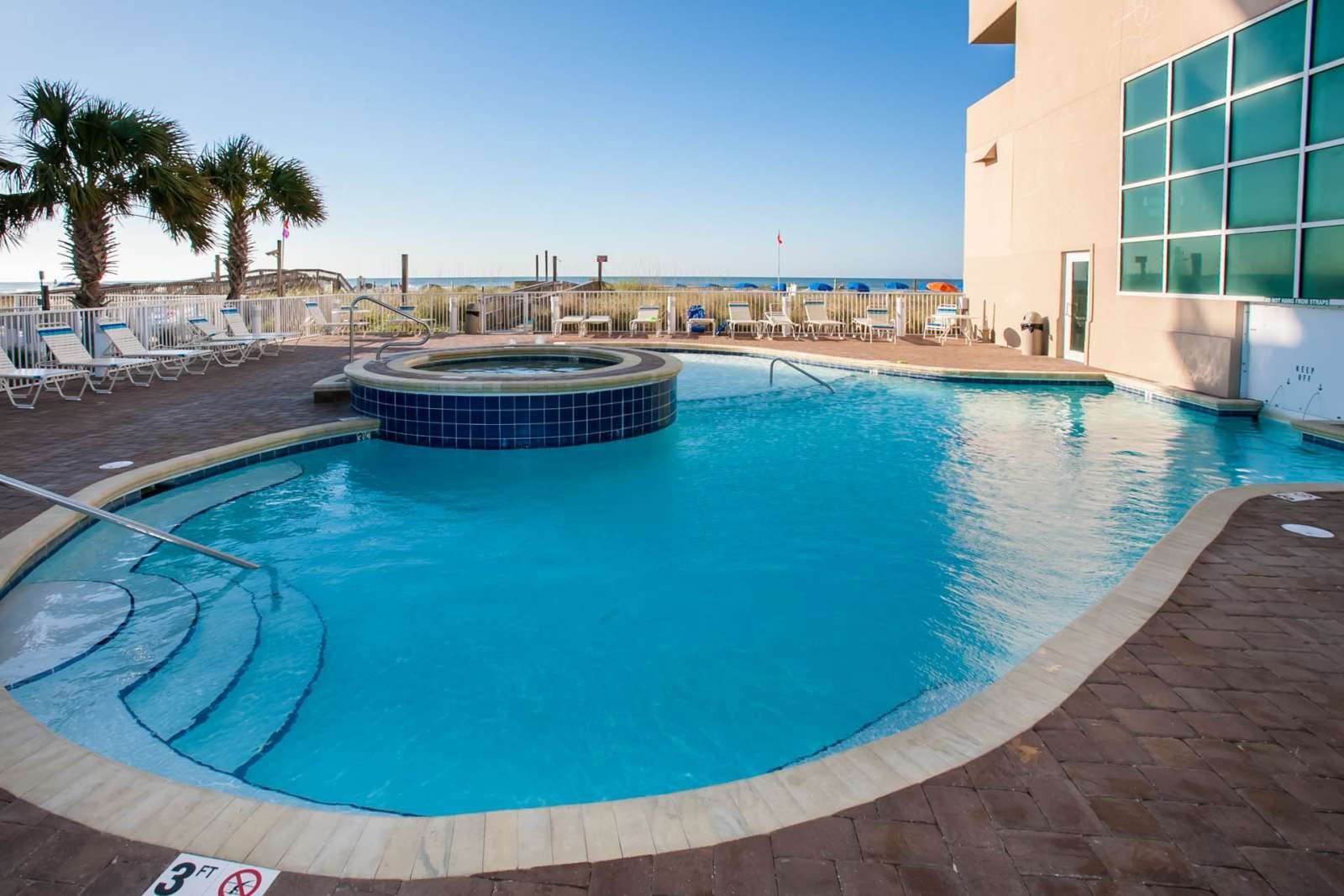 Outdoor pool and hot tub at Crystal Shores West condos in Gulf Shores Alabama
