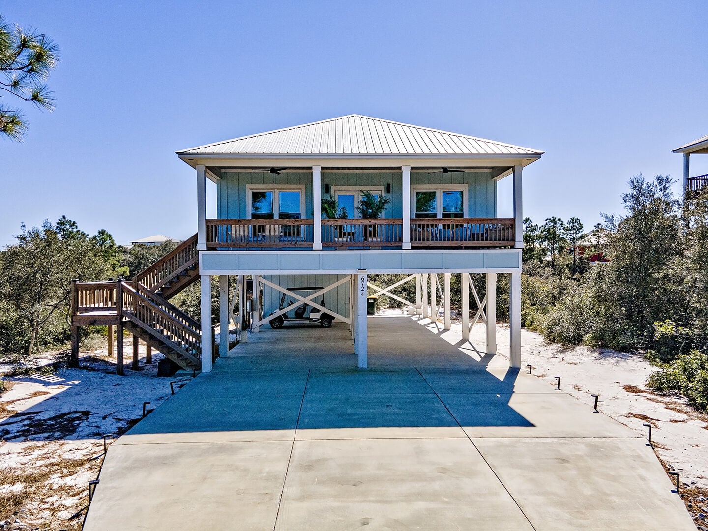 Beach house with covered porch and parking at Driftwood Daze in Fort Morgan, Alabama