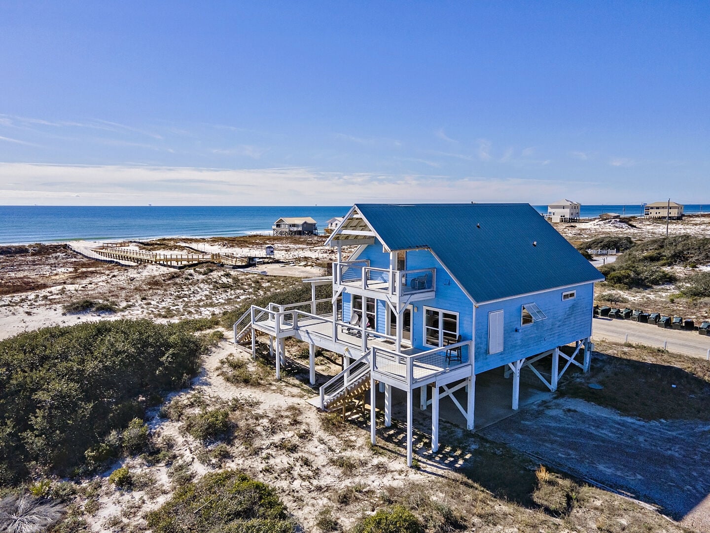 Aerial view of blue beach house by the Gulf at Dune Refuge in Fort Morgan, Alabama