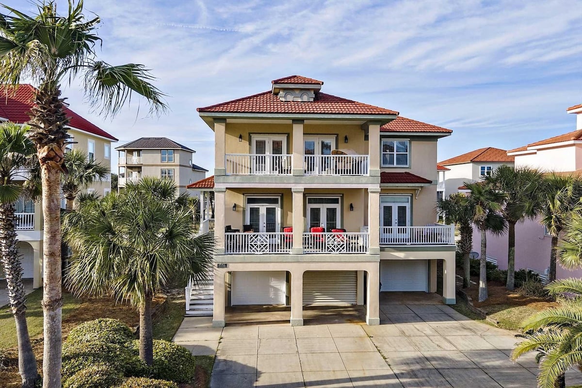 Beach house with palm trees at For the Shell of It in Gulf Shores, Alabama