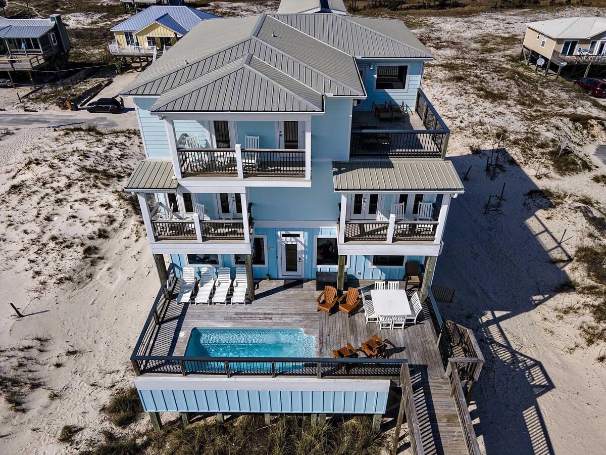 Aerial view of beach house with private pool at Happy Our in Fort Morgan, Alabama