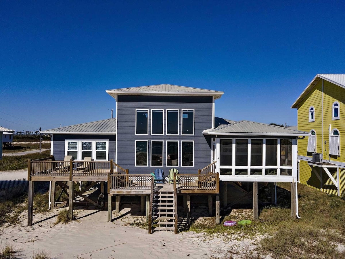Gray beach house with screened porch at High Tide in Fort Morgan, Alabama