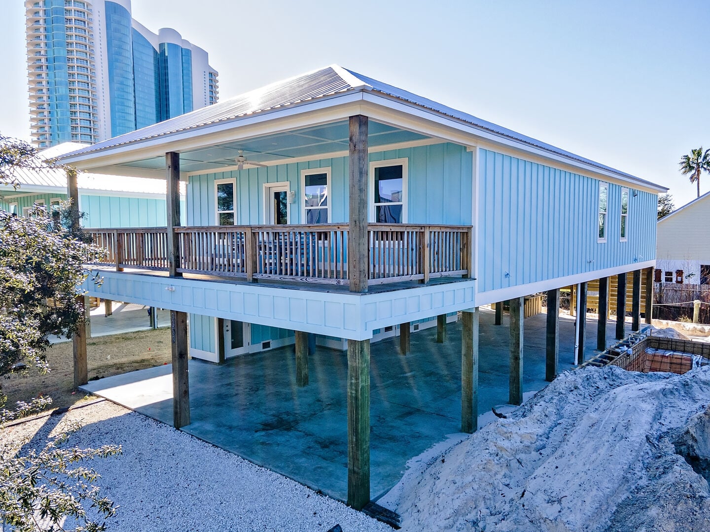 Light blue cottage on stilts at Orange Beach Cottage North in Orange Beach, Alabama