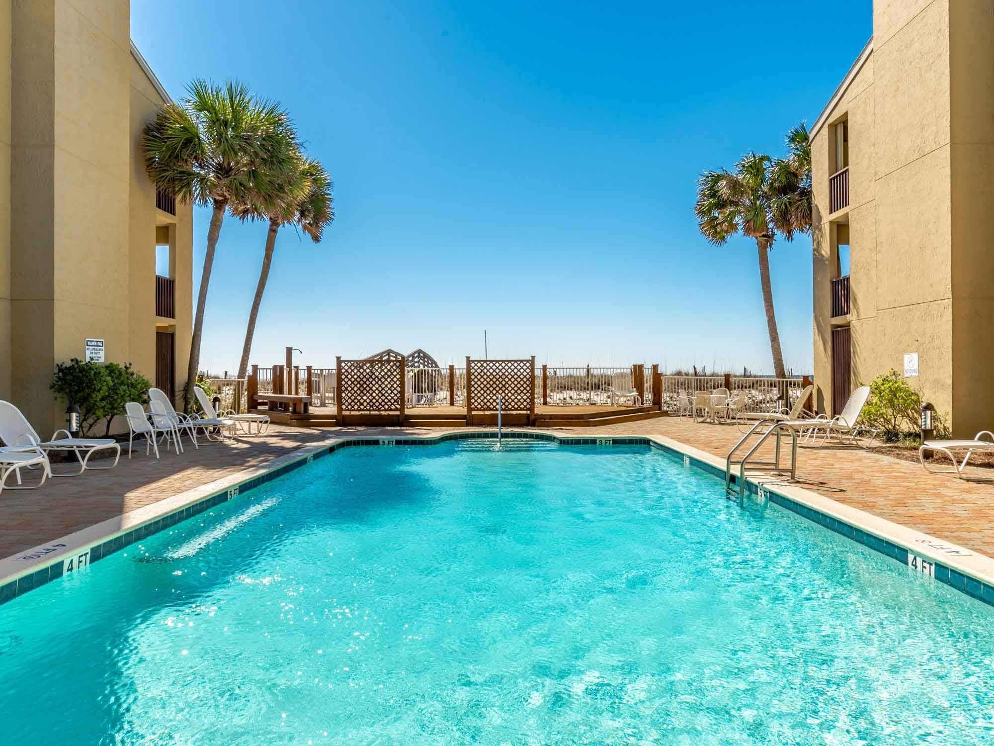 Outdoor pool at Shipwatch condos in Perdido Key, Florida with water view