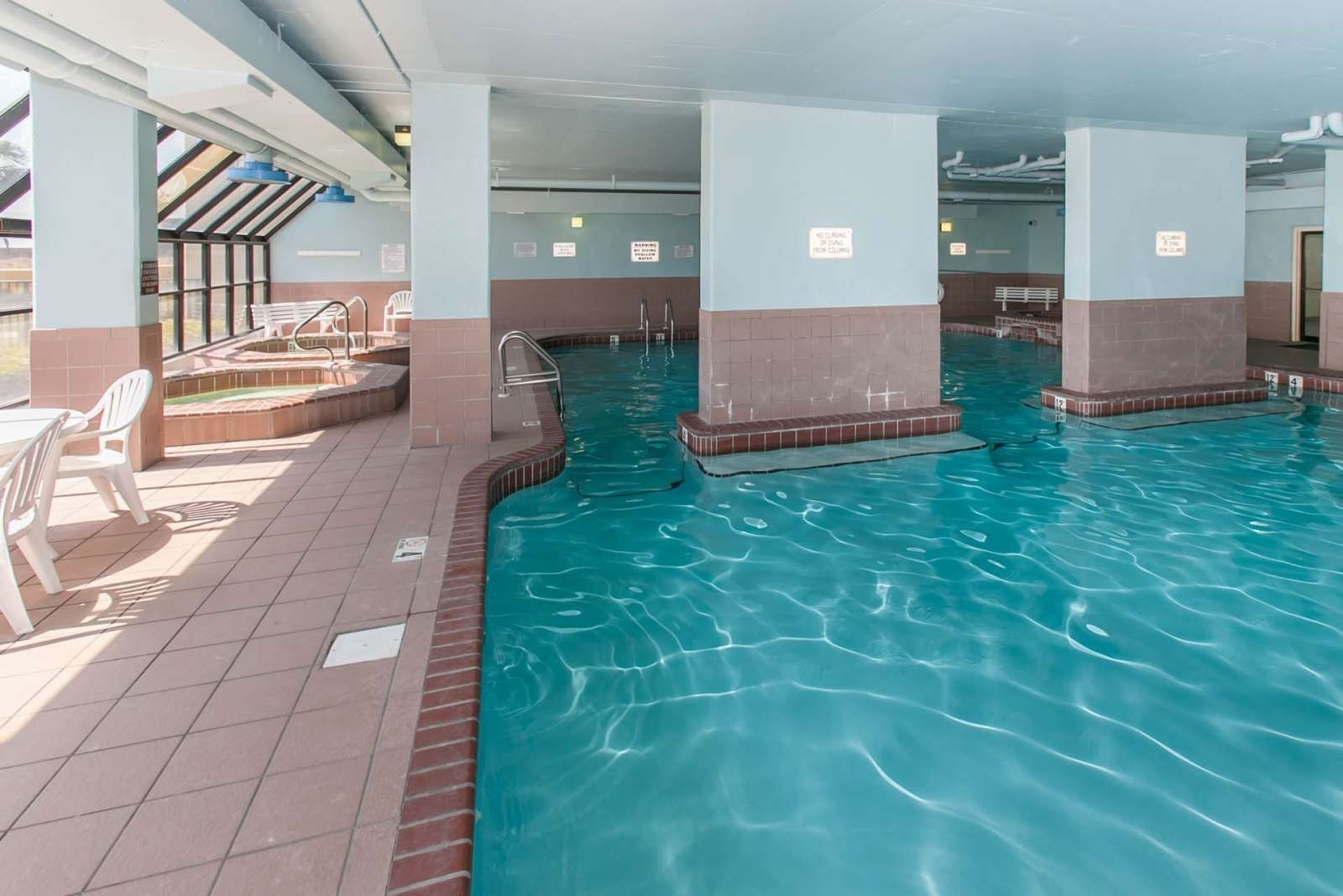 Indoor pool and seating area at Phoenix VI in Orange Beach, Alabama