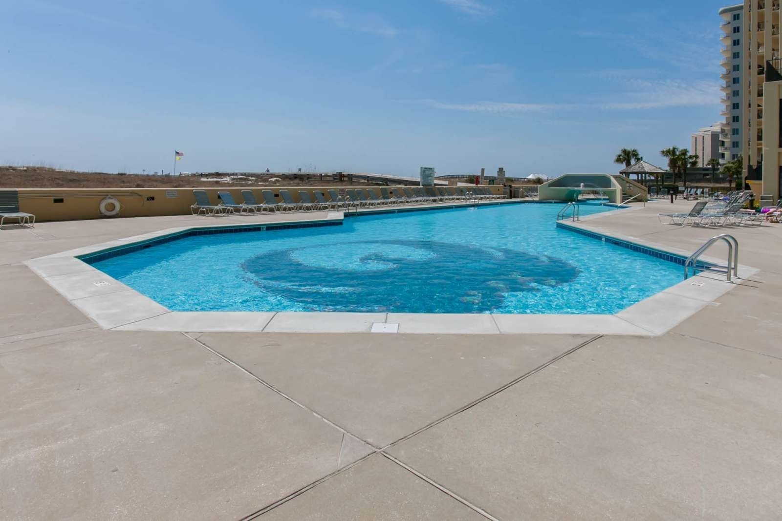 Outdoor pool and sun deck at Phoenix VI in Orange Beach, Alabama