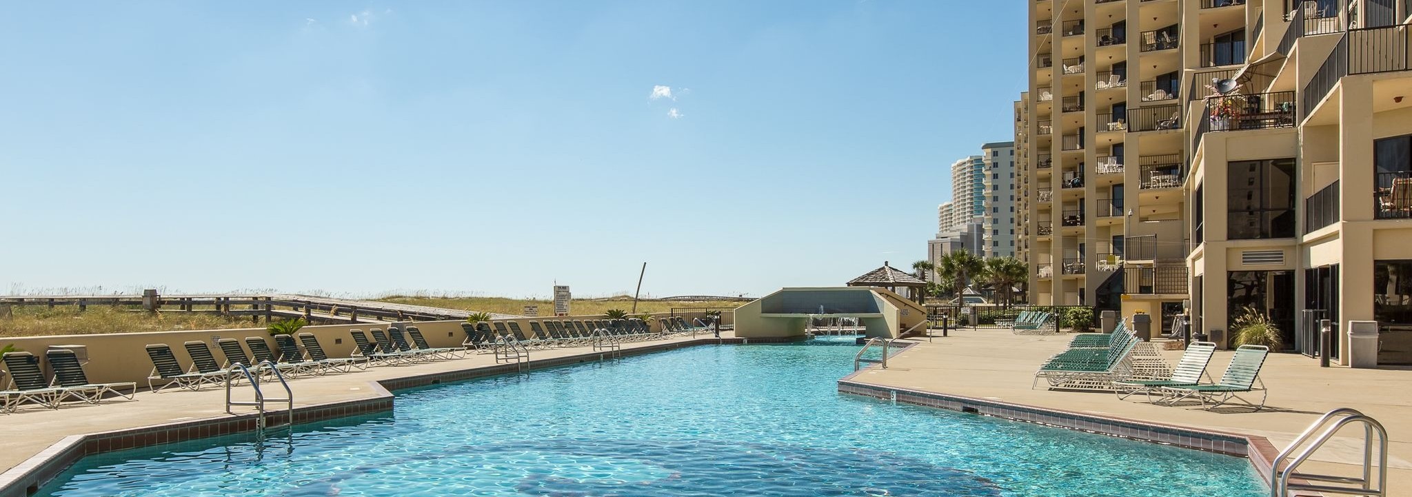 Large outdoor pool and sun deck at Phoenix VII in Orange Beach, Alabama