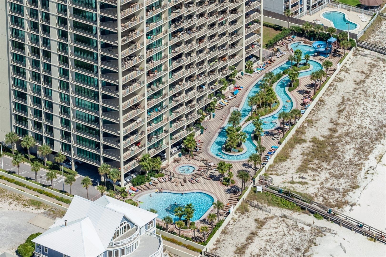 Aerial view of the lazy river and condo tower at Phoenix West in Orange Beach, Alabama