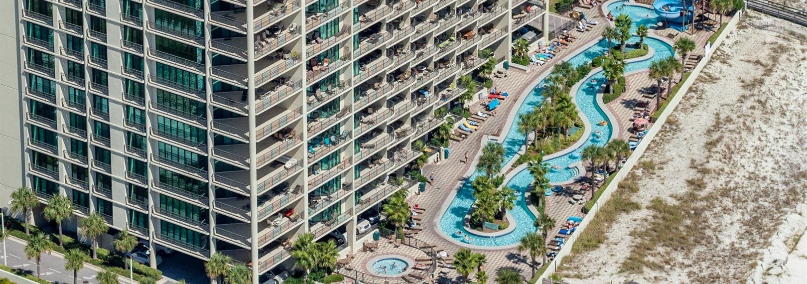 Aerial view of the lazy river and condo tower at Phoenix West in Orange Beach, Alabama
