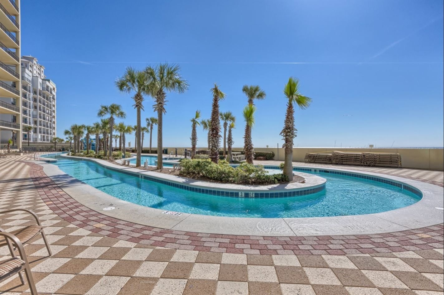 Lazy river with palm trees at Phoenix West in Orange Beach, Alabama