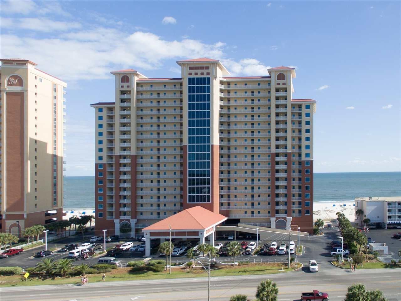 Aerial of the San Carlos tower with the beach behind in Gulf Shores Alabama