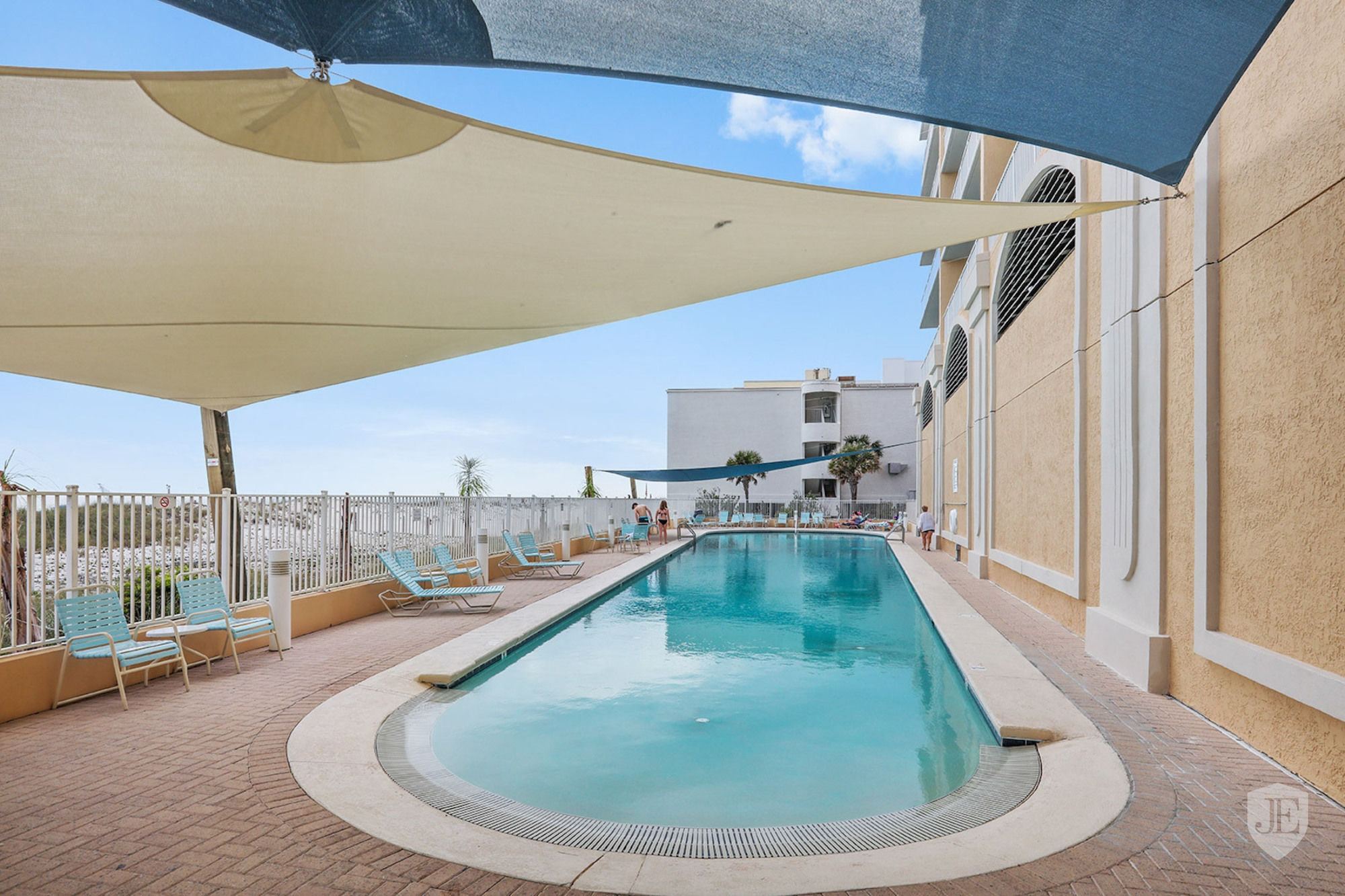 Outdoor pool with shade sails at San Carlos in Gulf Shores Alabama
