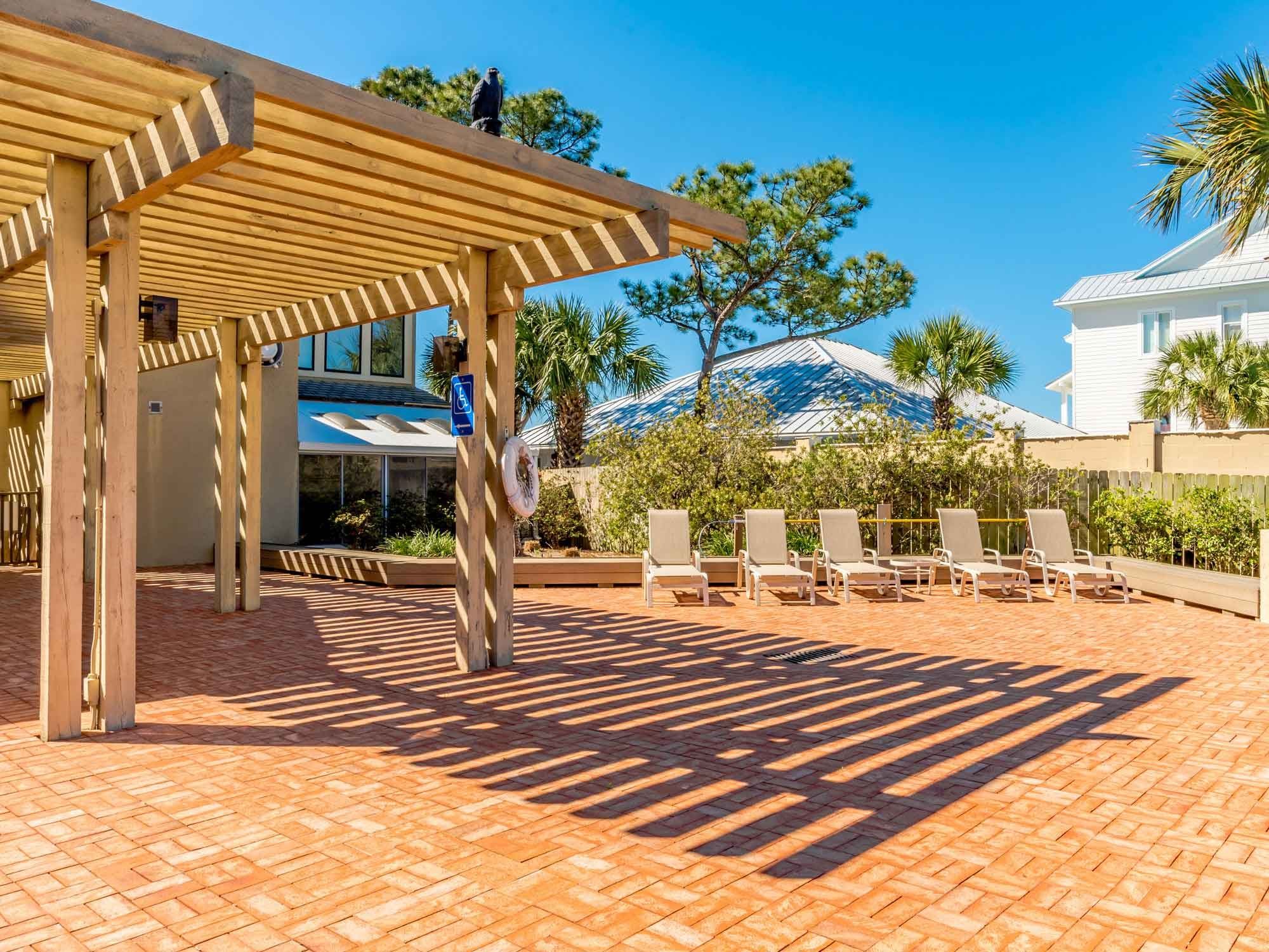 Pergola patio with lounge chairs at Shipwatch in Perdido Key, Florida